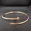 Cartier-Au750-Rose-Gold-Nail-Bangle-Small-Bracelet-1.webp Bracelet jonc clou Cartier en or rose 750, petit modèle, 9,1 g