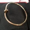 Cartier-Au750-Rose-Gold-Nail-Bangle-Small-Bracelet-2.webp Bracelet jonc clou Cartier en or rose 750, petit modèle, 9,1 g